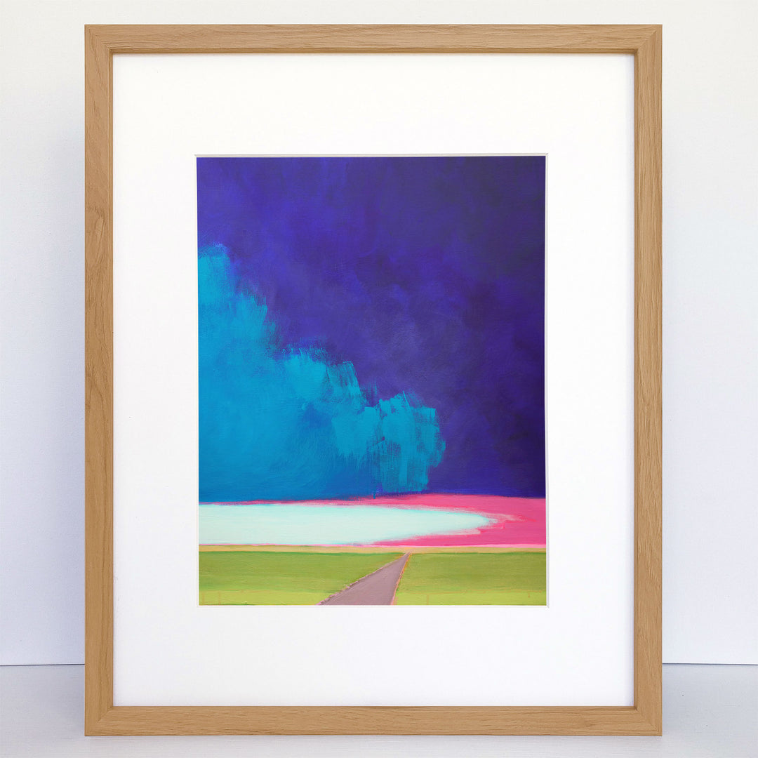 Framed print of an abstract landscape with a big stormy sky. The painting has bright pink, green and blue.